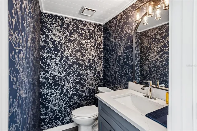 a bathroom with a sink toilet and a mirror