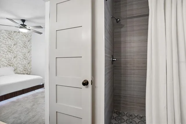 a bathroom with a shower and a sink