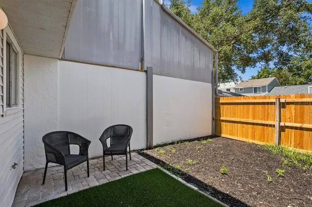 a backyard of a house with table and chairs