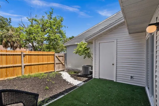 a backyard of a house with plants and outdoor seating
