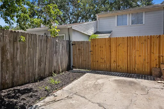 a view of a wooden house with a wooden fence