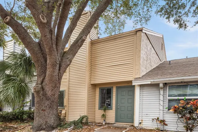 a view of a house with a tree
