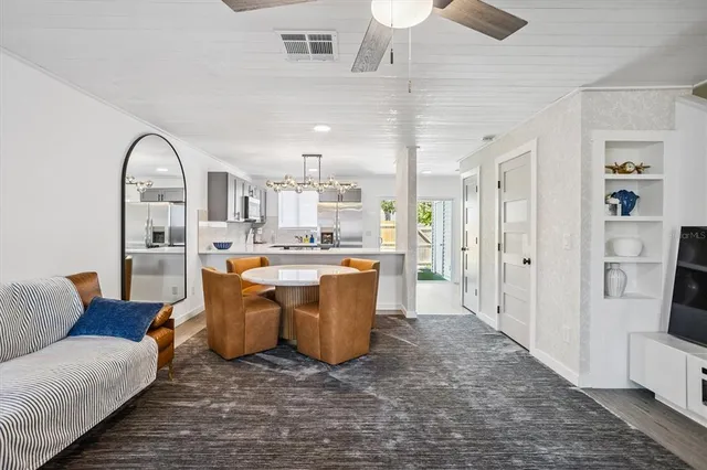 a living room with kitchen island furniture and a kitchen view