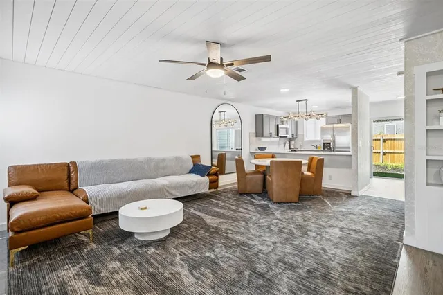 a living room with furniture a rug and white walls