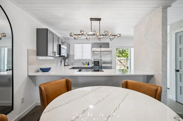 a large white kitchen with a large window