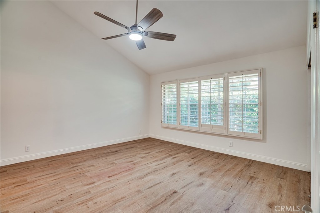 49 East Yale Loop, Unit 26 Irvine, CA 92604 - Photo 33 of 63 an empty room with wooden floor fan and windows