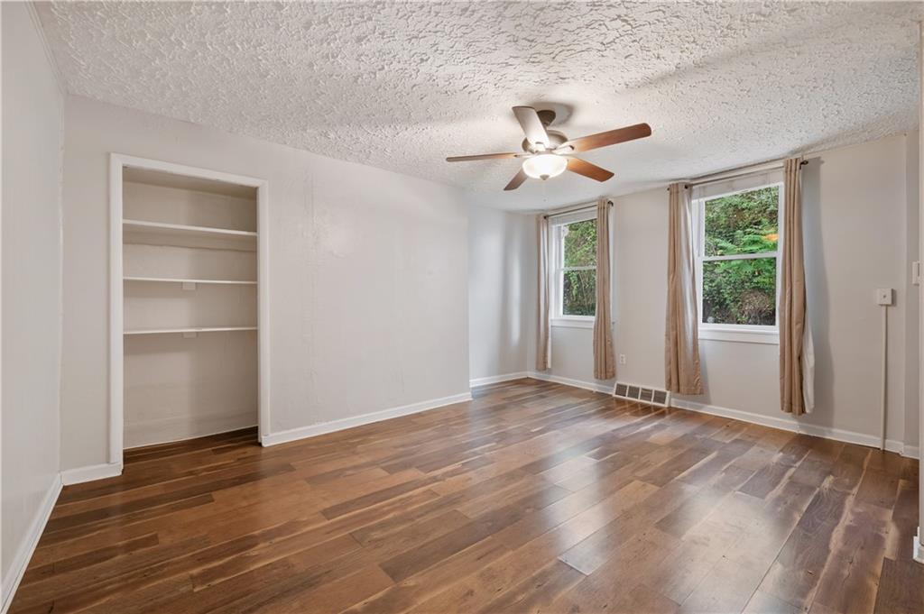 22 Eleanor Street Pittsburgh, PA 15203 - Photo 11 of 36 a view of an empty room with a window and wooden floor