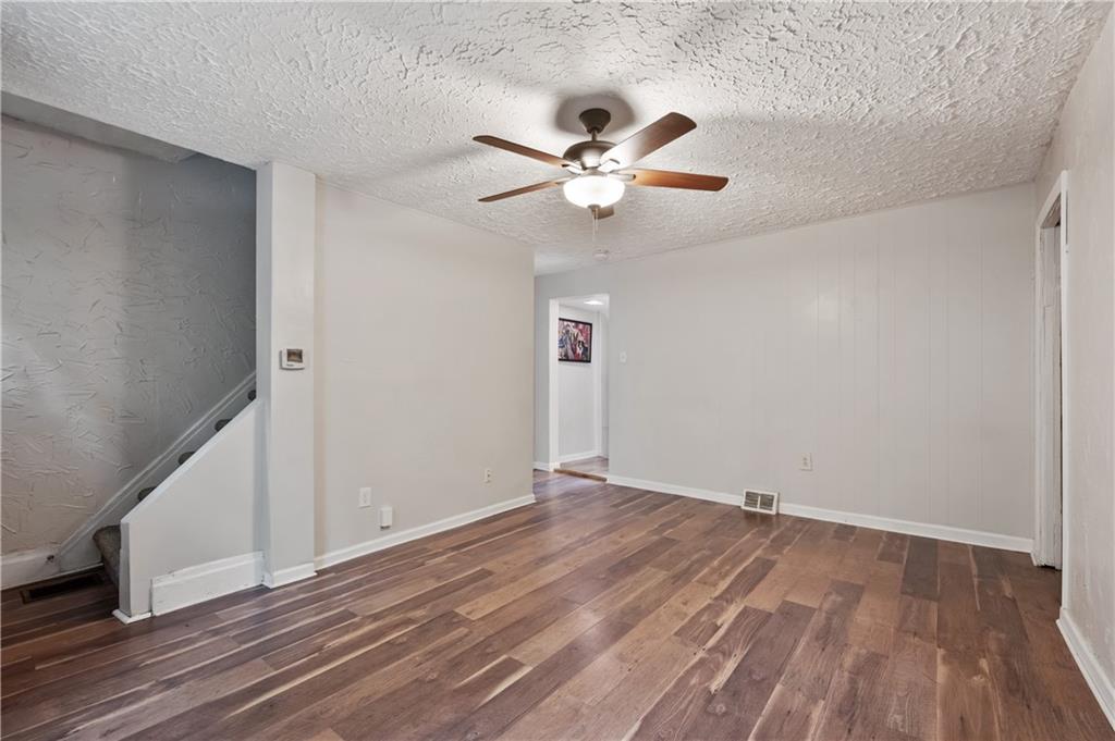 22 Eleanor Street Pittsburgh, PA 15203 - Photo 13 of 36 an empty room with wooden floor fan and windows