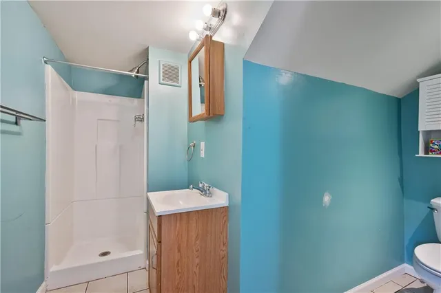 a view of a backyard with chairs and a fire pit