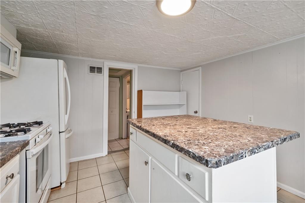 22 Eleanor Street Pittsburgh, PA 15203 - Photo 4 of 36 a kitchen with granite countertop a sink stove and refrigerator