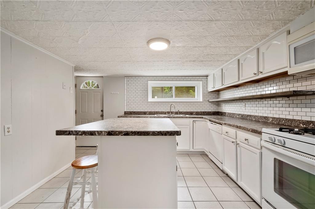 22 Eleanor Street Pittsburgh, PA 15203 - Photo 5 of 36 a kitchen with granite countertop a sink and cabinets