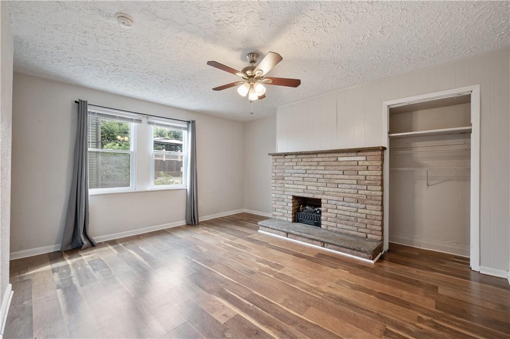 22 Eleanor Street Pittsburgh, PA 15203 - Photo 9 of 36 an empty room with windows fireplace and a ceiling fan
