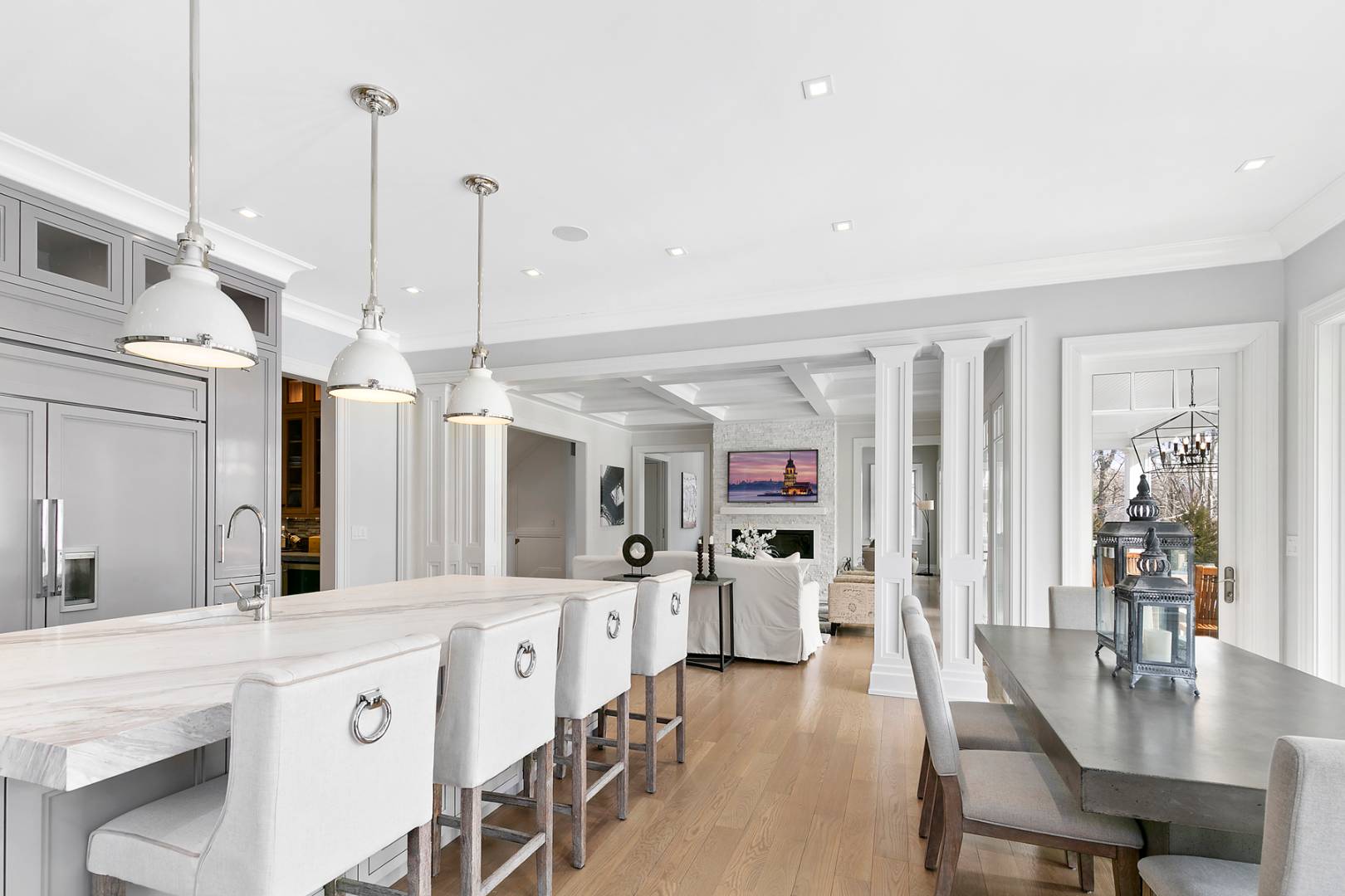 2 Frazier Avenue Southampton, NY 11968 - Photo 4 of 12 a large kitchen with cabinets a sink dishwasher a dining table and chairs with wooden floor