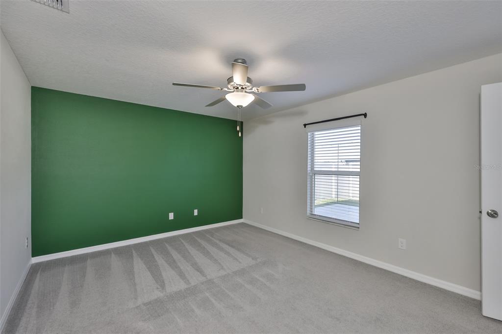 31867 Barrel Wave Way Wesley Chapel, FL 33545 - Photo 18 of 45 a view of an empty room with a window
