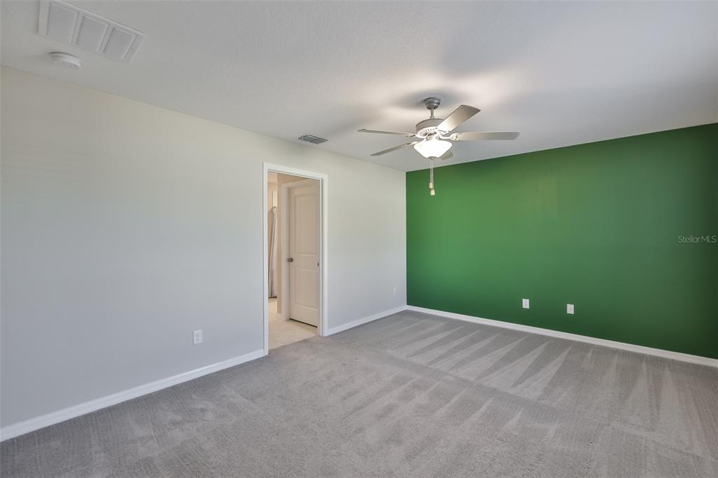 31867 Barrel Wave Way Wesley Chapel, FL 33545 - Photo 20 of 45 a view of a room with a ceiling fan and a fan