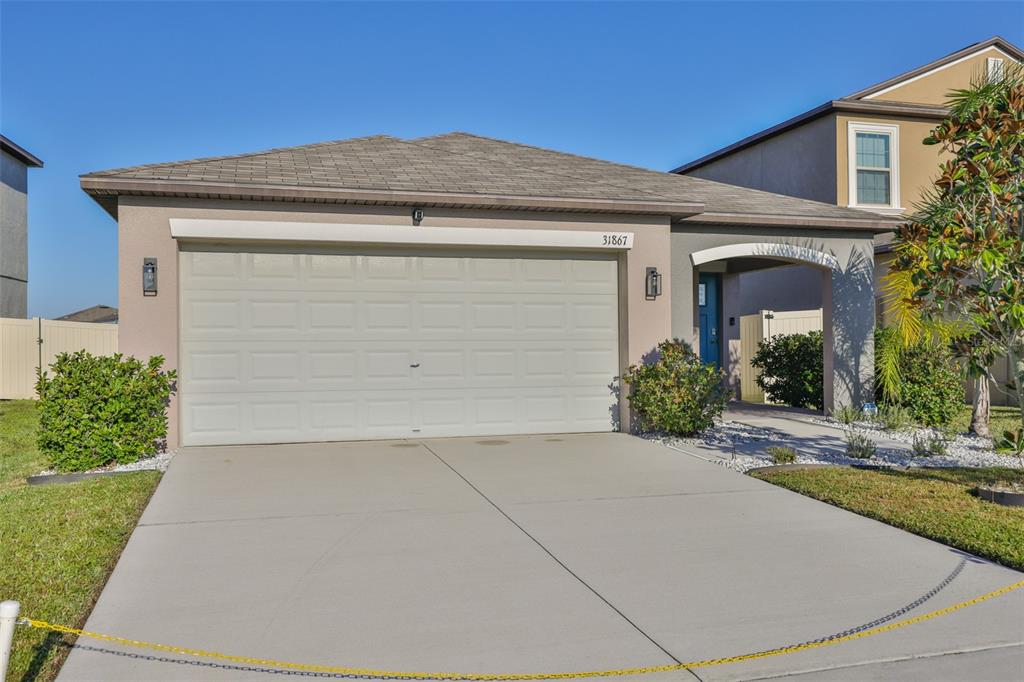31867 Barrel Wave Way Wesley Chapel, FL 33545 - Photo 2 of 45 front view of house with potted plants