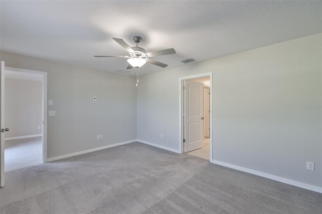 31867 Barrel Wave Way Wesley Chapel, FL 33545 - Photo 21 of 45 an empty room with a ceiling fan and a window