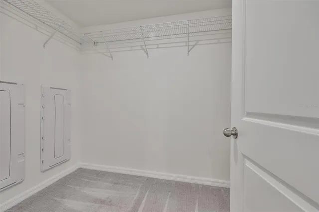 an empty room with a mirror and a fan