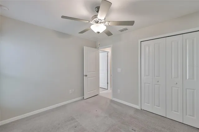 a view of an empty room with a fan