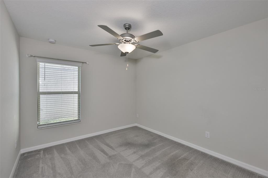 31867 Barrel Wave Way Wesley Chapel, FL 33545 - Photo 27 of 45 an empty room with a window and a fan
