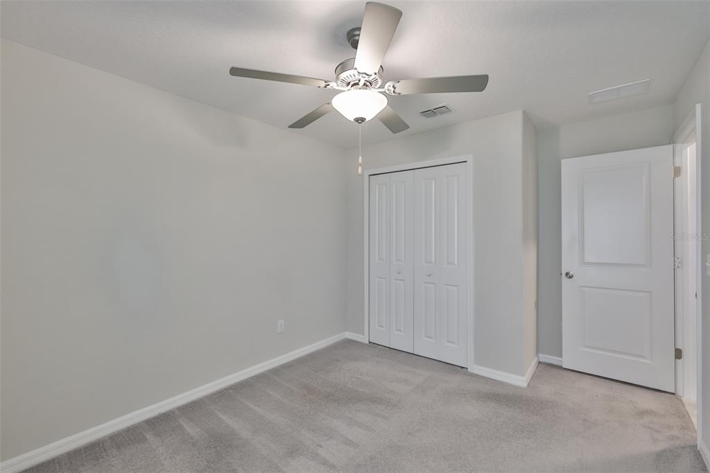 31867 Barrel Wave Way Wesley Chapel, FL 33545 - Photo 28 of 45 a view of an empty room with a fan