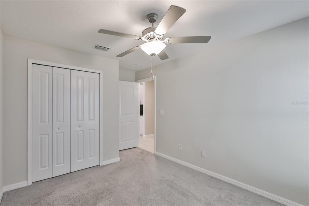 31867 Barrel Wave Way Wesley Chapel, FL 33545 - Photo 29 of 45 an empty room with a chandelier fan and a window