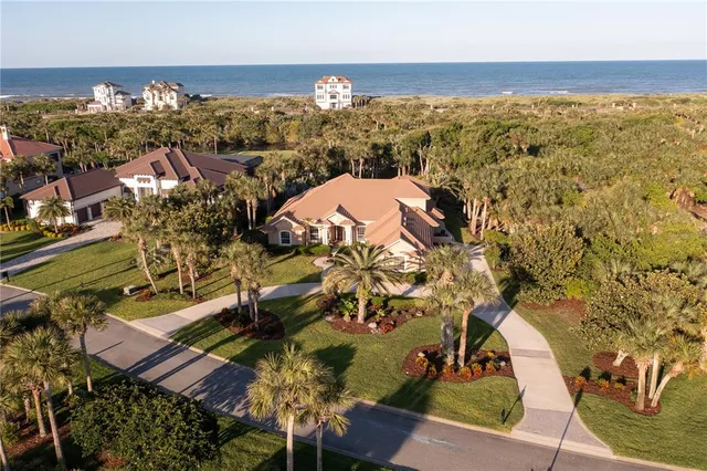 an aerial view of a house with a ocean view
