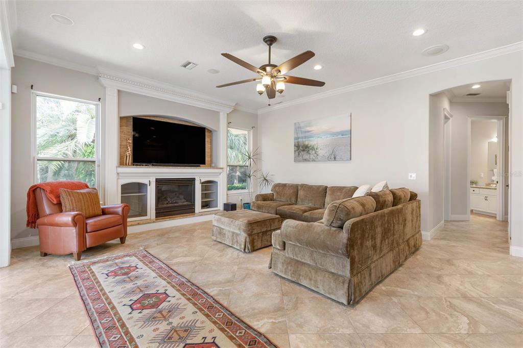 67 Island Estates Parkway Palm Coast, FL 32137 - Photo 22 of 84 a living room with fireplace furniture and a flat screen tv