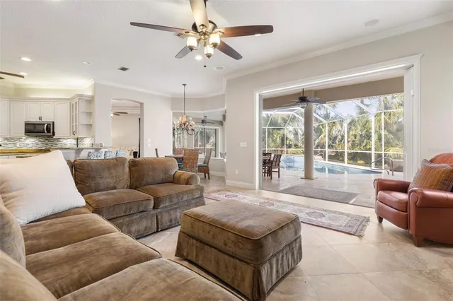 a living room with furniture and a ceiling fan