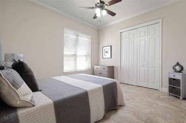 a bedroom with a bed and ceiling fan