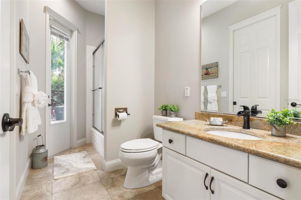67 Island Estates Parkway Palm Coast, FL 32137 - Photo 27 of 84 a bathroom with a granite countertop sink a toilet a mirror and shower