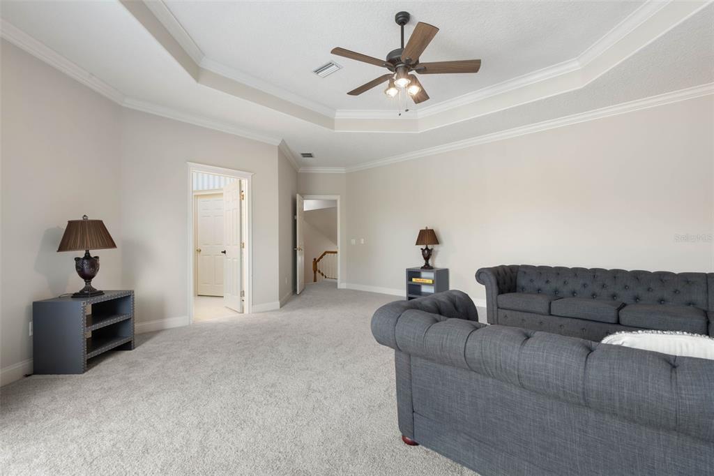 67 Island Estates Parkway Palm Coast, FL 32137 - Photo 32 of 84 a living room with furniture and a ceiling fan