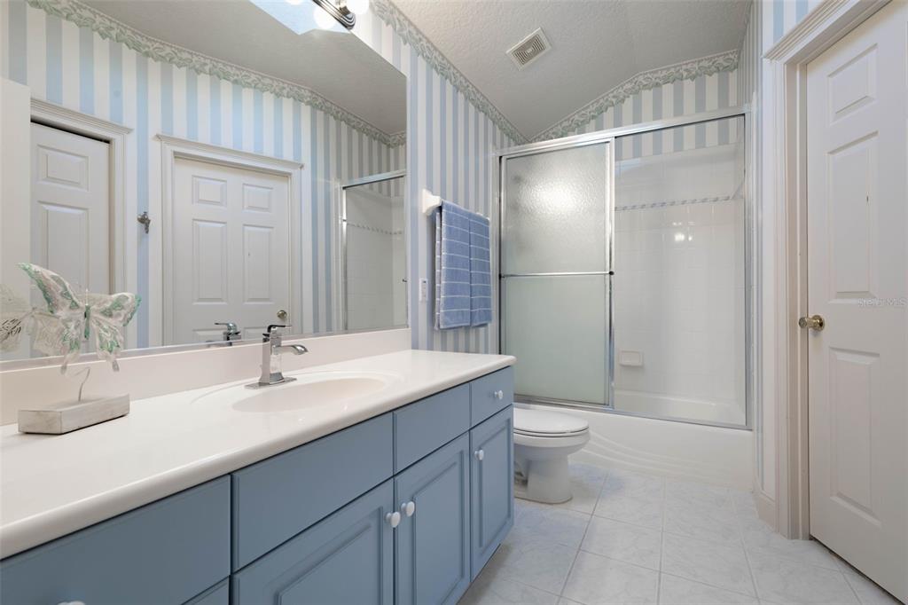 67 Island Estates Parkway Palm Coast, FL 32137 - Photo 33 of 84 a bathroom with a double vanity sink toilet and shower