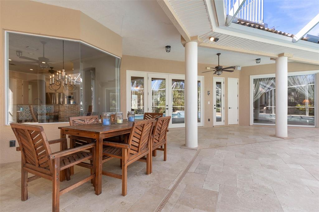 67 Island Estates Parkway Palm Coast, FL 32137 - Photo 40 of 84 a dining room with furniture a chandelier and kitchen view