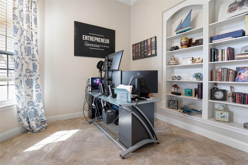 67 Island Estates Parkway Palm Coast, FL 32137 - Photo 9 of 84 a view of a workspace with furniture and a bookshelf