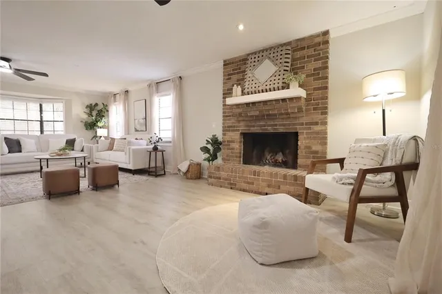 a living room with furniture a table and wooden floor