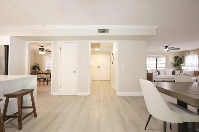 a kitchen with kitchen island granite countertop a table chairs refrigerator a sink and a stove