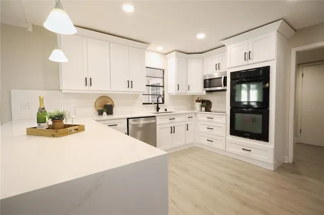 a kitchen with cabinets and stainless steel appliances