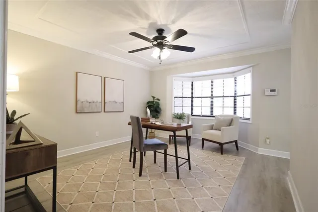a dining room with chandelier and wooden floor