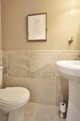 a view of a kitchen with wooden cabinets and a white door