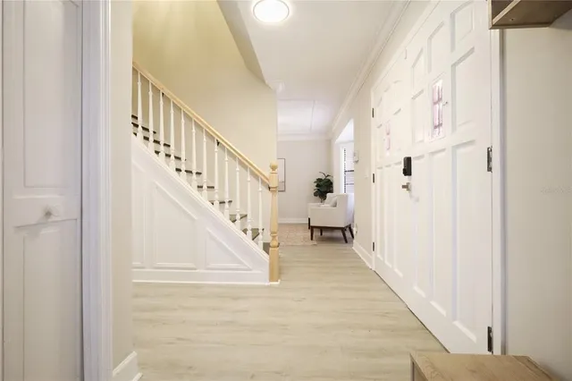 a living room with furniture a dining table and wooden floor