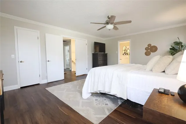 a spacious bedroom with a bed and a chandelier