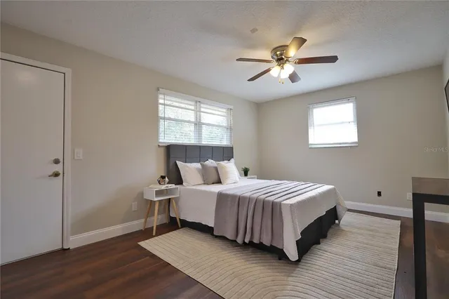a bathroom with a granite countertop sink toilet and a mirror