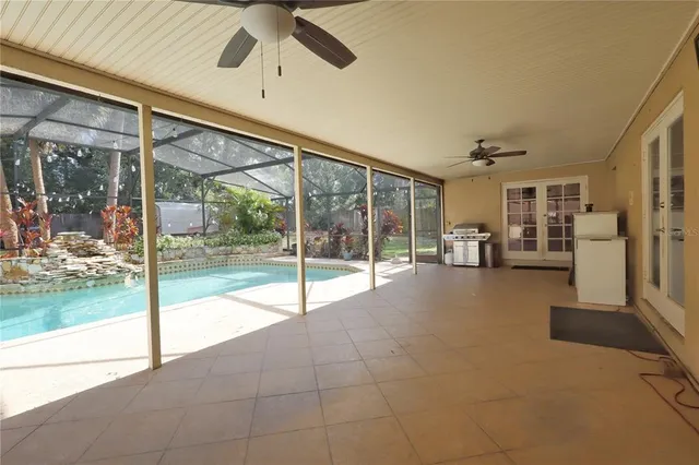 a swimming pool with yard in front of it