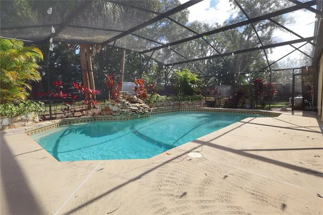 a view of a house with backyard and sitting area