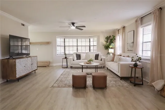 a living room with furniture and a large window