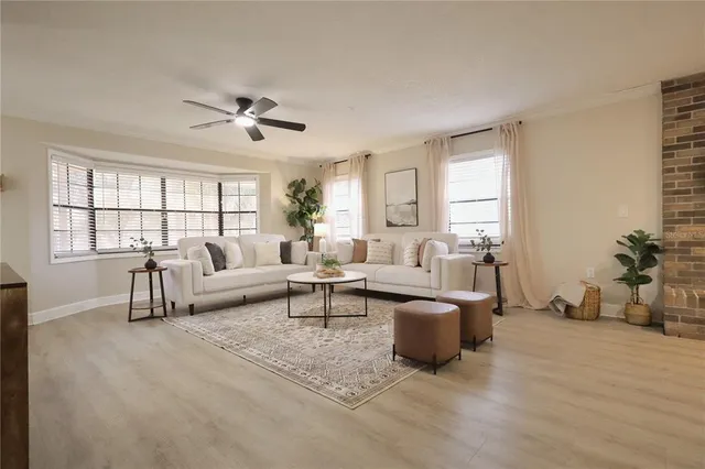 a living room with furniture a rug and a flat screen tv
