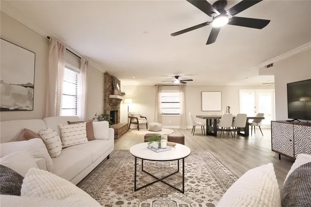 a dining room with furniture a fireplace and wooden floor
