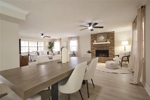 a living room with furniture two window and a chandelier