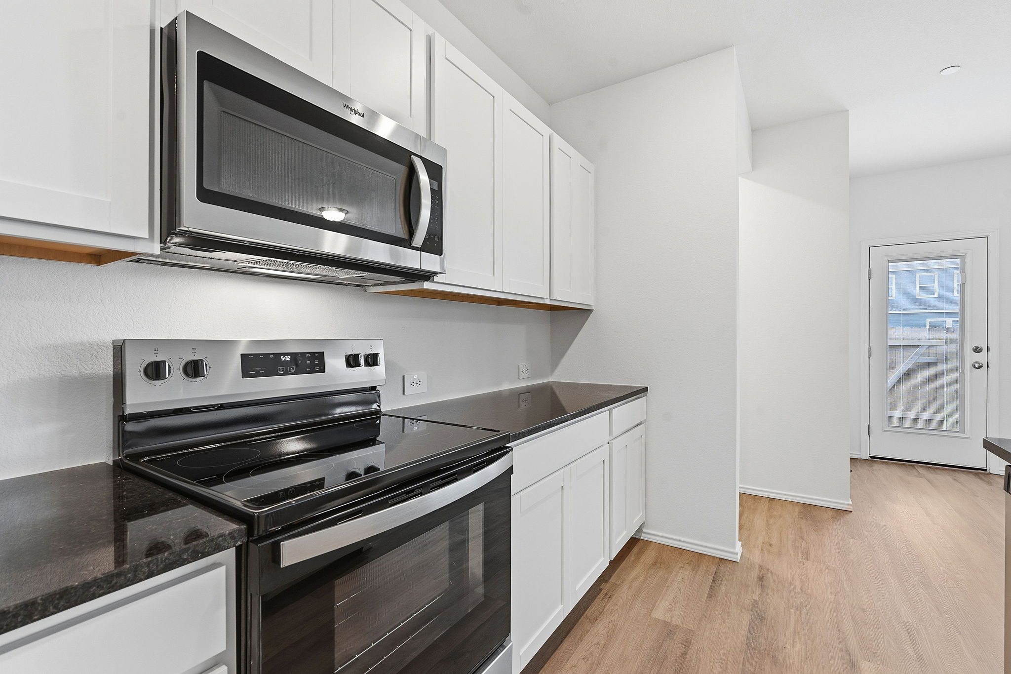 164 Cinnabar Lane, Unit 2 Kyle, TX 78640 - Photo 8 of 21 Kitchen area featuring stainless steel appliances, including an over-the-range microwave and electric range